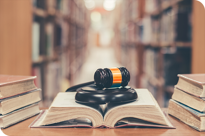 Gavel and open book in library