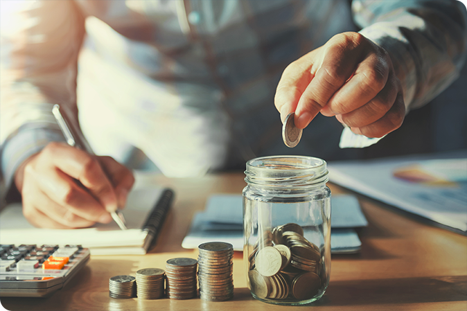 Man putting money in jar