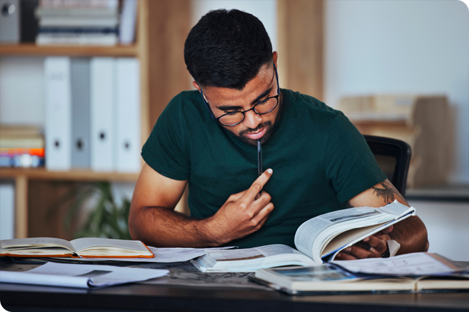 Man reading book at desk