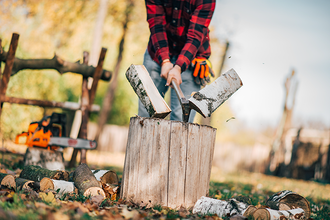 Person splitting wood with axe