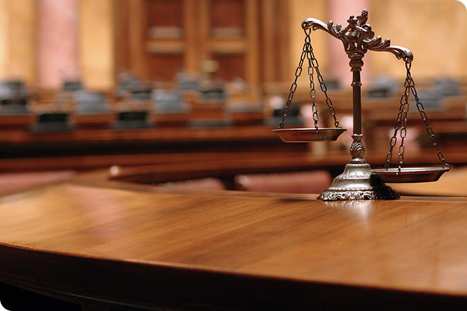 Law scales on desk in courtroom