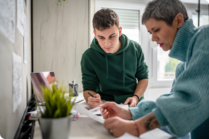 Woman tutoring young man