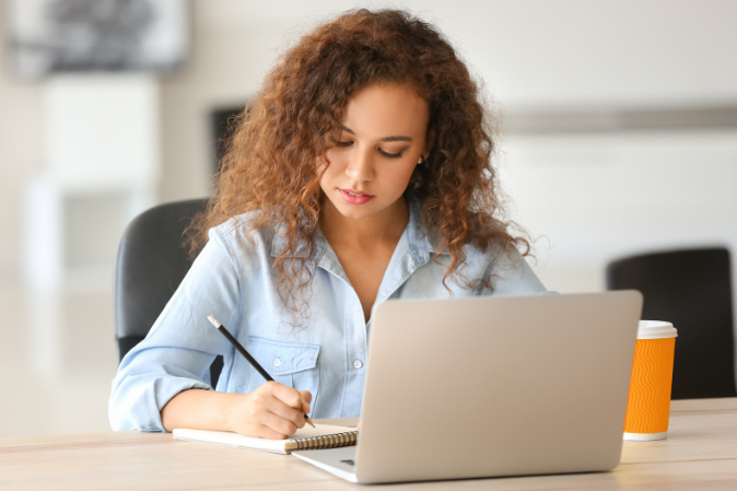 Young woman studying on laptop