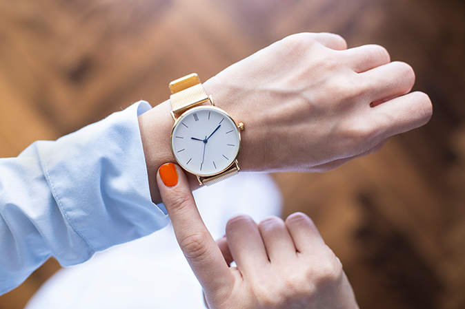 Young woman checking watch