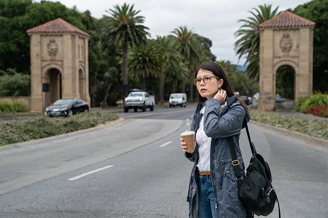 asian Japanese woman exchange student gazing into space with coffee while waiting her classmate at the entry of school university in California usa