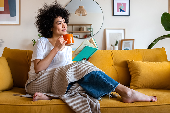 Young woman on couch reading