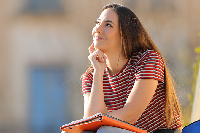 Young woman smiling and looking up