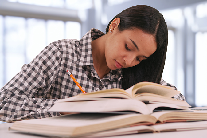 Woman studying with books