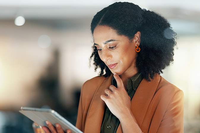 Businesswoman reading off of a tablet