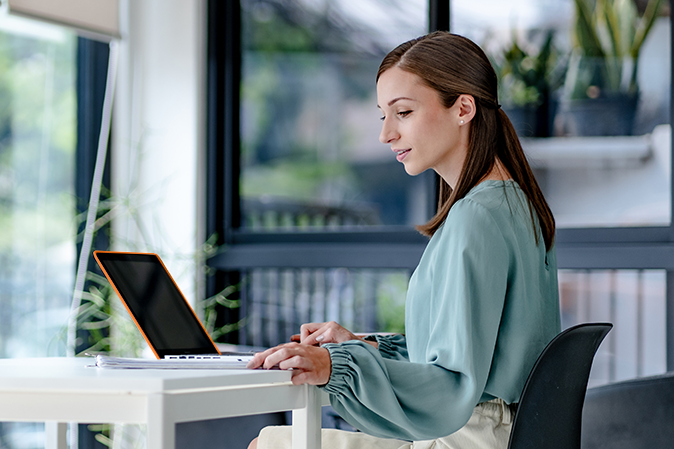 Professional woman at a desk using a laptop