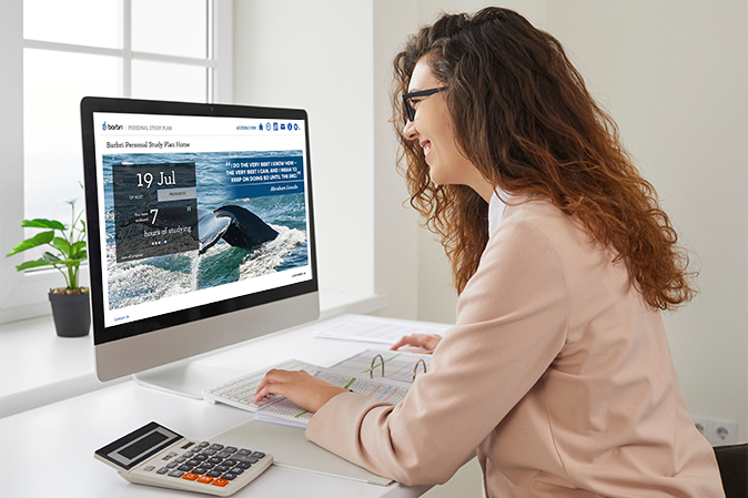 Smiling woman working at home or office sitting at desk with computer and talking to colleague via videochat. Employee chatting with coworker planning business schedule on pc with chart and tables.