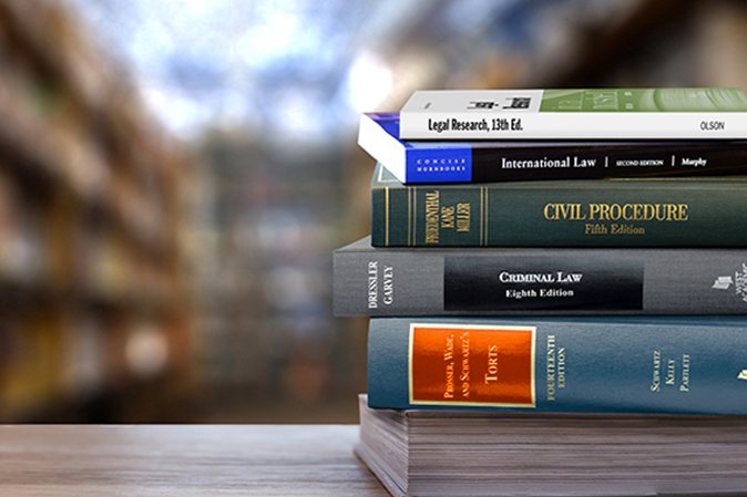 Stack of West Academic books on a desk in a library