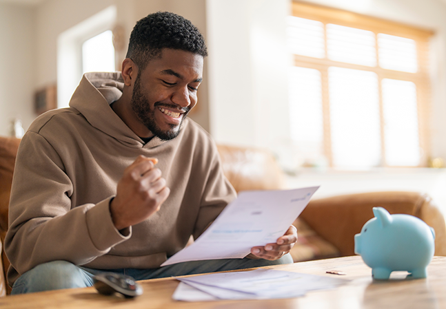 happy man reading letter response to his job application loan mortgage Happy smiling excited