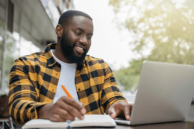 Young male student studying outside